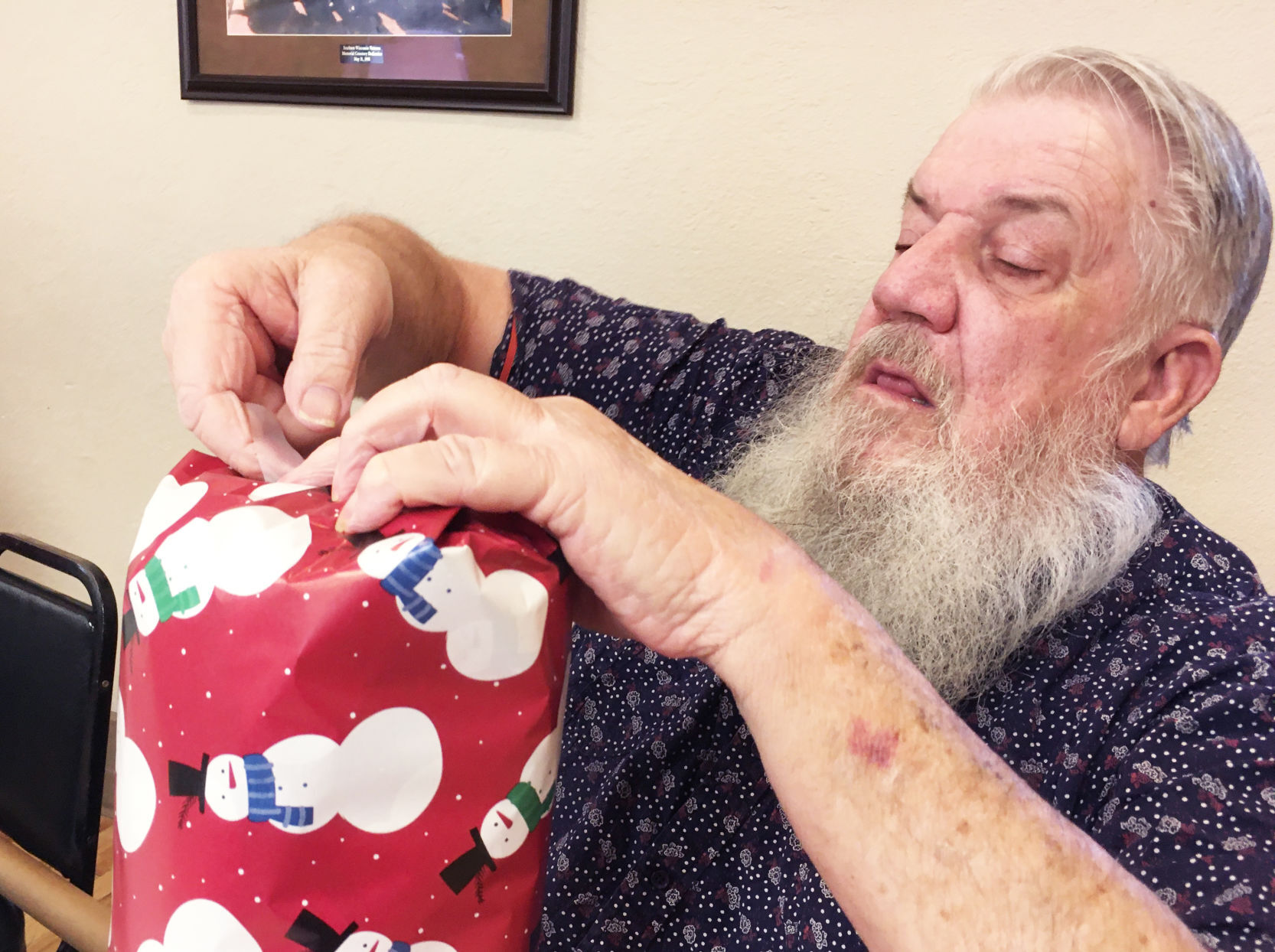 Oliver Davidson wraps a gift for holiday delivery to veterans home residents